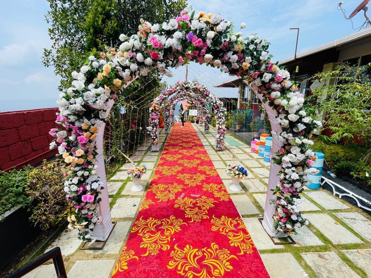Floral wedding entrance arch and petal aisle